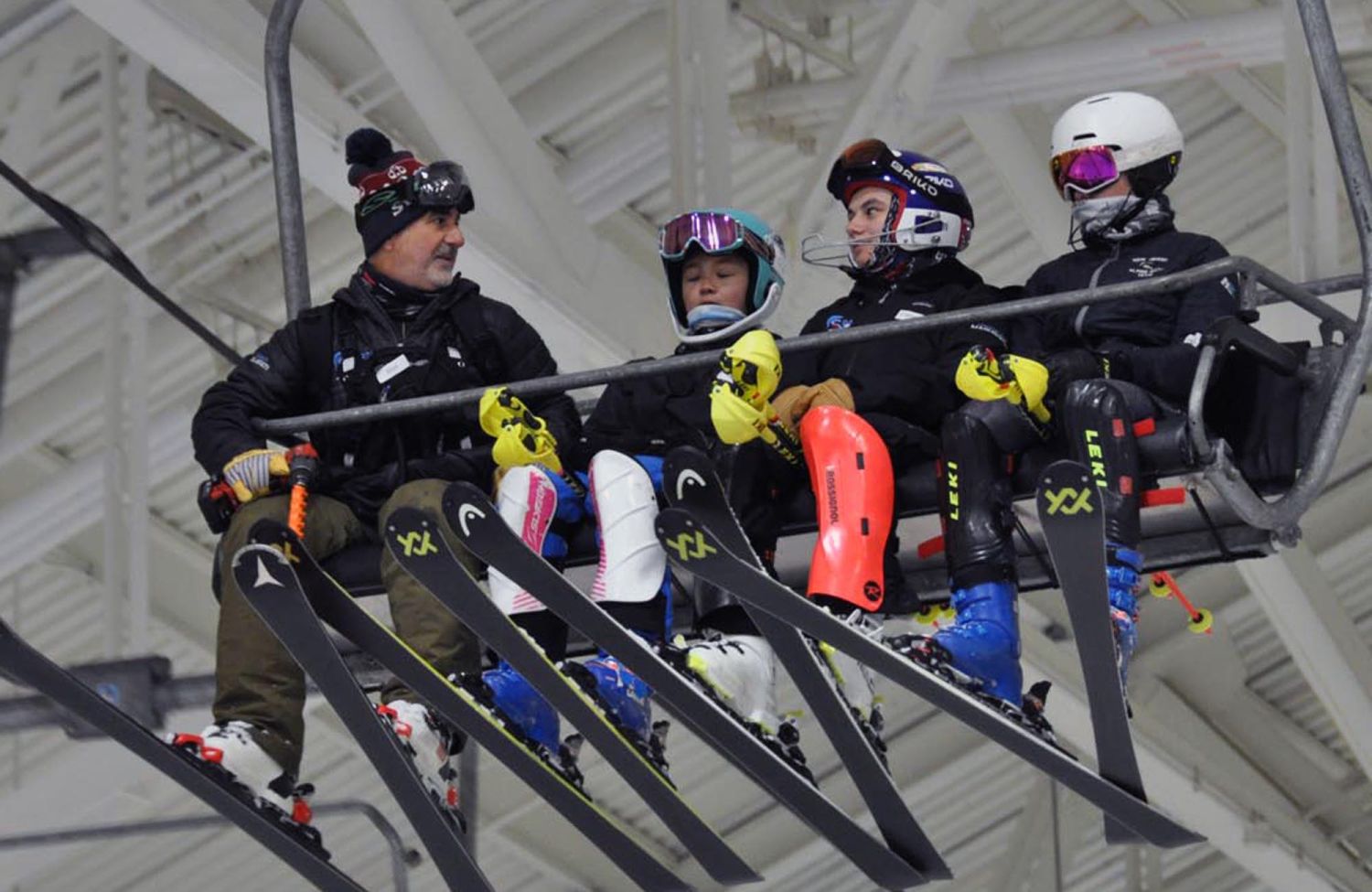 Coach Rod riding lift with racers